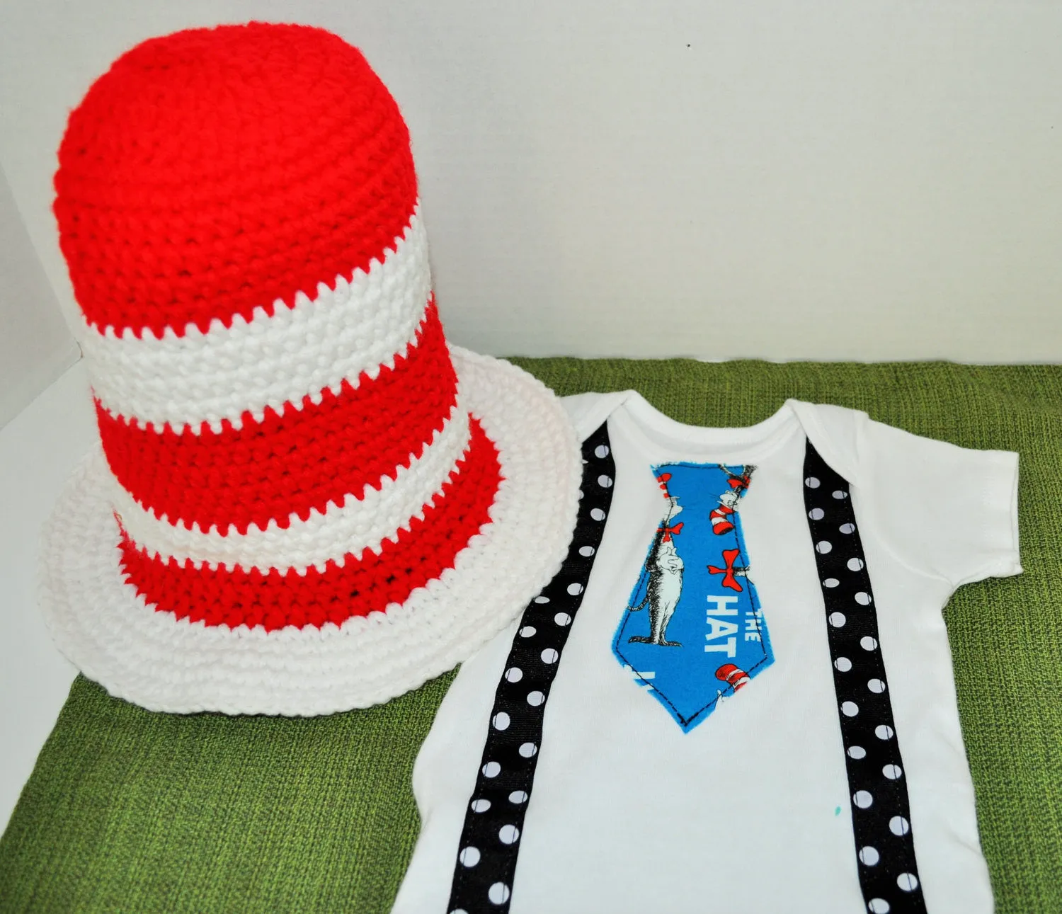 Dr. Seuss cake smash tie and black with white polka dot suspenders and red and white crochet Dr Seuss hat . birthday, cake smash